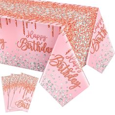 a pink birthday party table with confetti and sparkles on the tablecloth