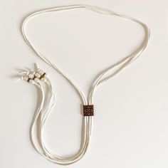 New Handmade Bolo Necklace By Western General Boutique! You Will Love The Soft Elegance Of This Necklace! It Is Absolutely Beautiful On, With Unbelievably Soft Deerskin Leather In A Creamy White Color. Each Strand Of Leather Is About 50” Long And Is Finished With Pearls And Copper Beads. Each Freshwater Pearl Bead Has A Unique Look And Shape, Giving This Necklace Gorgeous Detail. The Copper Slider Bead Is Dainty And Allows For Easy Adjustment. This Will Be Super Cute With Cutoffs Or Dresses For White Adjustable Lariat Jewelry, Handmade Long White Necklace, Adjustable Pearl White Bohemian Jewelry, Adjustable Bohemian Pearl White Jewelry, Elegant Adjustable Cream Jewelry, Elegant White Jewelry With Adjustable Length, White Adjustable Jewelry For Gift, White Adjustable Jewelry As Gift, Wedding Lariat Jewelry With Adjustable Length