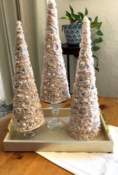 three small christmas trees sitting on top of a tray