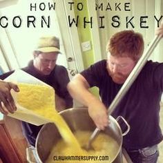 two men are in the kitchen making something yellow with a large metal pot and ladle