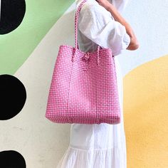 This versatile tote is a must-have accessory for all your warm-weather & cool weather adventures. Whether you're hitting the beach, the farmer’s market, lounging by the pool, or embarking on a weekend getaway, the Maxi Ella Tote has got you covered. Crafted from recycled plastic, this eco-friendly tote reduces environmental impact. Spacious enough to carry all your essentials plus more! Say hello to the perfect summer companion! Product Overview: Materials: Recycled plastic Size: 14” H (25” with Chic Pink Shoulder Beach Bag, Chic Pink Beach Bag For Daily Use, Pink Chic Beach Bag, Handwoven Vacation Bags, Pink Rectangular Bucket Bag For Vacation, Rectangular Pink Bucket Bag For Vacation, Summer Everyday Bucket Bag With Rolled Handles, Trendy Pink Bucket Bag For Beach, Everyday Summer Bucket Bag With Rolled Handles