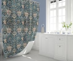 a bath room with a shower curtain and a sink under a window in front of a window