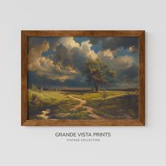 a painting hanging on the wall above a dirt road in front of a cloudy sky