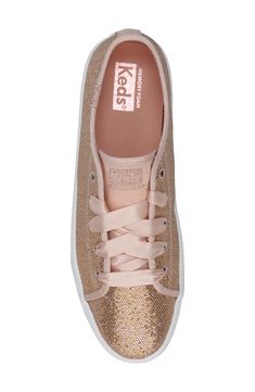 Your kiddo will love heading out in this shimmery sneaker fitted with grosgrain laces and a memory-foam footbed for everyday comfort. Lace-up style Memory foam cushioning Synthetic upper/textile lining/rubber sole Imported Metallic Low-top Sneakers For Spring, Spring Metallic Low-top Sneakers, Gold Synthetic Sneakers For Spring, Pink Glitter Sneakers For Spring, Glitter Lace-up Sneakers For Spring, Sporty Glitter Sneakers For Spring, Rose Gold Sparkle, Gold Sparkle, Keds