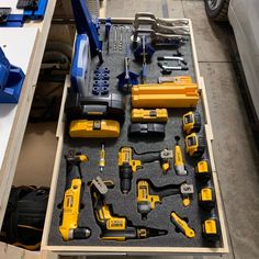 a drawer filled with tools on top of a table