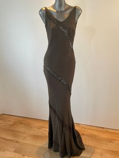 "A unique opportunity to own a beautiful Vintage Caroline Holmes Couture Gown at just 10% of it's original value from our Knightsbridge Salon.  The Gown is handmade from the finest silks, silk lined to create that extra special feeling of elegance to it's wearer. Description: Chocolate beaded bias cut gown with V neck and low V back. Made from a silk chiffon overlay on to a silk crepe backed satin. Side zipper fastening into small beaded train.   UK Size 10 Measurements: Bust 34\" Waist  25\" Hi Floor-length Evening Dress With Beaded Straps, Evening Gown With Beaded Straps And Floor-length, Floor-length Evening Gown With Beaded Straps, Embellished Silk Maxi Evening Dress, Floor-length Gown With Beaded Straps For Evening, Floor-length Embellished Silk Dress, Embellished Silk Floor-length Dress, Embellished Silk Prom Gown, Embellished Silk Gown For Prom