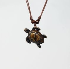 "Turtle Pendant Necklace. Adjustable Necklace. Sea Turtle Design. Meaning of the Turtle: Represents Protection, Longevity and Order This necklace can be used short or long : you can adjust the cord when ever you want. Turtle Dimensions Style A-1, A-2: 1.75\" Inches Long Turtle Dimensions Stile B-1, B-2 1.5\" Inches x 1\" Inch Satisfaction guaranteed. FAST SHIPPING! This beautiful necklace is unisex. Wear it as a choker or a long necklace. The necklace is fully adjustable from 16\" Inches to appr Nickel-free Brown Necklace For Gift, Adjustable Brown Necklace For Gifts, Adjustable Brown Necklace For Gift, Sea Turtle Design, Sea Turtle Necklace, Turtle Jewelry, Turtle Gifts, Turtle Bracelet, Turtle Design