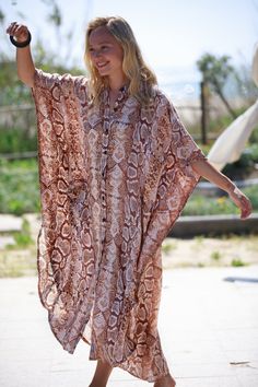 "This Oversize kaftan dress is the best choice for the summer and can be transformed for any occasion from casual to Special Occasion, day-to-night. The Dress is made of rayon, which is very lightweight and flowy.  It has lots of style and presence and feels so cool and chic. It is guaranteed to turn heads around... :) Fits all sizes - up to XXL and looks great on any body type. The Dress has pockets, and buttons, and is made of Rayon. COLOR - Snakeskin (Beige and Brown tones) Also Available in - 7 more prints! for example -  Blue and White Stripes - https://www.etsy.com/listing/728071093/ Brown Leopard Print - https://www.etsy.com/listing/728070405/ SIZE: Available in One Size - Up to 48.5\" (123 cm) bust and hips. Length - front 49.5\" (126 cm), back 54\" (138 cm) ⊱I ship your item/s wit Spring Brown Tunic Kaftan, Brown Tunic Kaftan For Spring, Brown Long Maxi Dress For Beach Cover-up, Summer Bohemian Kaftan With Batwing Sleeves, Bohemian Batwing Sleeve Summer Kaftan, Bohemian Batwing Sleeve Kaftan For Summer, Bohemian Maxi Dress With Batwing Sleeves For Summer, Summer Beach Maxi Dress With Batwing Sleeves, Oversized Summer Tunic Kaftan