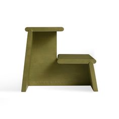 a green chair sitting on top of a white floor