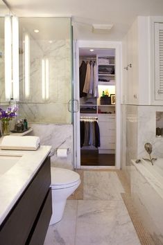 a bathroom with a toilet, sink and bathtub next to a walk in shower