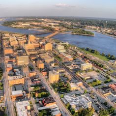 an aerial view of a city with lots of buildings and water in the middle of it