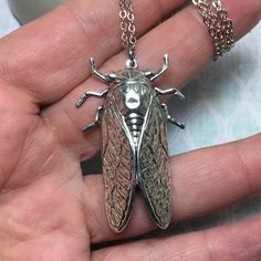 "Large cicada bug made of solid brass with silver plating and a locket hidden on the reverse side! Beautiful detail on this 2\" bug that is made with vintage molds that are nearly 100 years old. A truly unique necklace. Perfect gift for the bug lover! The locket is silver plated and in a tear drop shape. It can hold a special sentiment or tiny image. Check out this same locket in brass: https://www.etsy.com/listing/554860158/hidden-locket-necklace-cicada-large?ref=shop_home_active_6&pro=1&am Secret Compartment Necklace, Insect Jewelry Design, Unique Locket Necklace, Bug Necklace, Beetle Necklace, Vintage Molds, Unique Locket, Bug Jewelry, 1 Am