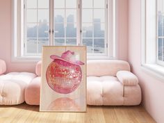 a pink living room with a painting on the floor