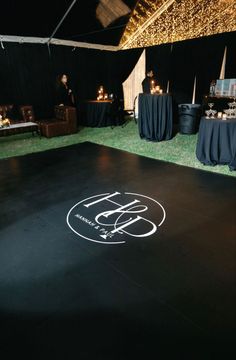 the dance floor is decorated with lights and black linens for an outdoor party or function