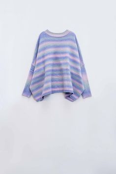 Introducing our Oversized Multicolor Sweater in beautiful shades of pastel purple and blue – a cozy and stylish addition to your winter wardrobe. This comfortable sweater features stripes in various hues, creating a visually appealing and vibrant design.  Designed for the coldest days of the year, this sweater boasts a super oversized fit and a high neck to keep you warm and snug. The stripe design adds a playful touch, making it a standout piece for your daily wear.  Crafted from a chunky knit blend of 55% Polyester and 45% Acrylic, this sweater ensures both warmth and comfort. The high collar neckline enhances the cozy feel, providing extra protection against chilly weather.  Our model is showcasing the size U, and with her measurements (33-24-35, Height: 5'9''), you can visualize the ov Striped Sweater For Winter Loungewear, Oversized Purple Sweater For Layering, Oversized Soft Knit Purple Sweater, Purple Winter Loungewear Sweater, Sweater With Side Slits, Shades Of Pastel, Tan Scarf, Multicolor Sweater, Comfortable Sweater