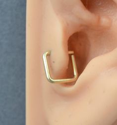 an ear with a gold ring on top of it