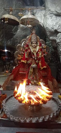 an idol sitting on top of a fire pit