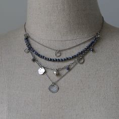 "The Raw Silver and Sapphire Layered Necklace for Women is a stunning piece of handcrafted jewelry. Made with sterling silver and featuring blue sapphire gemstones, this necklace showcases the natural beauty of these materials. The beaded necklace is oxidized and polished, adding depth and charm to the overall design. Its boho style gives it a trendy and fashionable appeal. Layered necklace for women is perfect jewelry gift for sister or wife. Dress up your necklace on special occasion, or send Cheap Silver Layered Jewelry, Cheap Bohemian Silver Layered Necklace, Cheap Silver Layered Beaded Necklace, Cheap Silver Beaded Chain Layered Necklace, Boho Choker Necklace Silver, Affordable Silver Layered Jewelry, Trendy Jewelry Silver, Silver Multi-strand Sterling Silver Necklace, Silver Dangle Necklace With Polished Beads