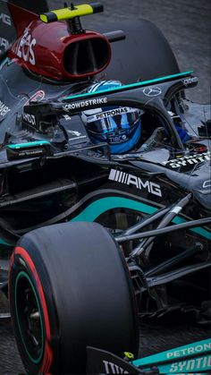 the front end of a racing car on a race track