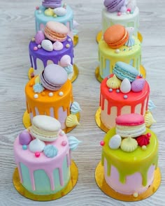 there are four cakes that have different designs on each cake, and one is decorated with colorful icing