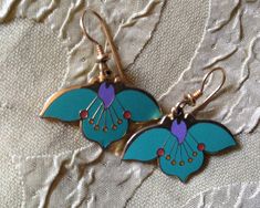 "Laurel Burch Earrings Turquoise DESERT FLOWER FANS Cloisonne  Dangle French Ear Wires Vintage Jewelry 1980s Laurel Burch Cloisonne Floral Earrings are done in pretty turquoise, accented with lilac, with pin dots of red; cool vintage finds from the 1980s. Two shimmering brass Cloisonne cuties. Each measure approx. 1\" X 1/2\" with 14k Gold Filled French Ear Wires with gold beads & coils. Signed on the back: DESERT FLOWER Laurel Burch.  A Genuine LAUREL BURCH COLLECTIBLE from the mid-1980s.This p Laurel Burch Earrings, Vintage Turquoise Flower Earrings, Vintage Turquoise Dangle Flower Earrings, Vintage Blue Flower Earrings, Vintage Green Flower Earrings, Vintage Blue Flower Earrings, Nickel-free, Vintage Blue Flower Earrings Nickel Free, Vintage Green Nickel-free Flower Earrings, Blue Vintage Flower Earrings Nickel-free