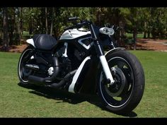 a black and white motorcycle parked in the grass