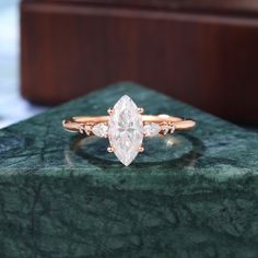 a diamond ring sitting on top of a green marble slab