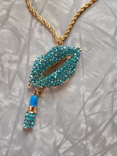 Blue rhinestone lips charm necklace. This is for 1 necklace. It is on a gold plated stainless steel 18 inch chain with a 2 inch extender. If you love statement jewelry than this piece is for you. Or wear to an 80's themed party.  If you have any questions please feel free to contact me.  Thank you for shopping at my store. Have a Totally Awesome Day! 😎 Trendy Bling Necklaces For Gifts, Trendy Bling Necklace For Gift, Trendy Necklace For Gift, Trendy Gold Rhinestone Necklace Gift, Trendy Gold Rhinestone Necklace With Bling, Rhinestone Lips, Totally Awesome, Blue Rhinestones, Themed Party