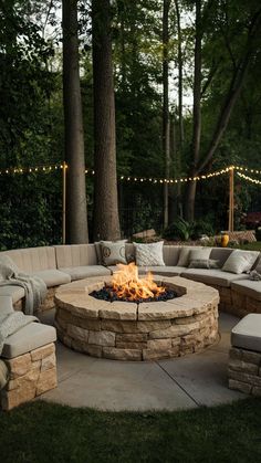 an outdoor fire pit with seating around it