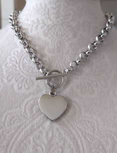 Handmade Silver Color Stainless Steel Chunky Heart Necklace, elegant polished Stainless Steel Heart Pendant and Toggle Clasp. 22mm wide Polished Silver Color Heart Pendant. ~8mm Wide Stainless Steel Silver Color Chain. Available in Bracelet style. **Total length is for the chain and toggle only not including the heart pendant** Same Necklace in Gold Color Stainless Steel available on the below listing: https://www.etsy.com/listing/693500869/gold-heart-necklace-all-gold-stainless?click_key=b01016 Chunky Heart Necklace, Boho Jewels, Color Heart, Necklace Elegant, Toggle Necklace, Necklace Chunky, Necklace Chain Lengths, Gold Heart Necklace, Silver Heart Necklace