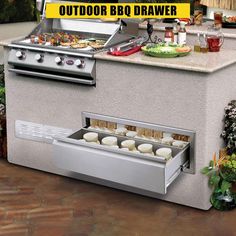 an outdoor bbq drawer with food in it and the words out door above it