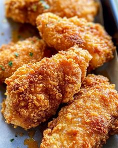 some fried food is on a plate with parmesan cheese and seasoning sprinkles