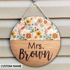 a wooden sign hanging on the side of a house that says,'mrs brown '