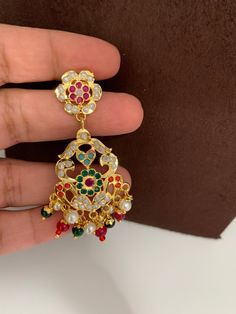 Hyderabadi Jadau Navratan Short NecklaceColor : GoldenSize : Necklace Length : Approx 16 Inches; Earring Length : 2.25 Inches Stones : Navratan Stones, Multi Color Beads Pearls Multicolor Jeweled Danglers As Gift, Multicolor Temple Jewelry Style Drop Earrings, Multicolor Jeweled Danglers As A Gift, Multicolor Temple Jewelry Drop Earrings, Multicolor Temple Jewelry Dangle Earrings, Multicolor Pendant Earrings For Celebration, Multicolor Dangle Temple Jewelry, Multicolor Jeweled Danglers For Gifts, Multicolor Pendant Earrings For Wedding