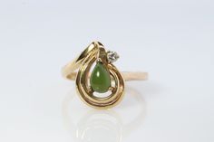 Wonderful Apple Green Jade Cabochon ring. Jade is translucent green color. Prong set. Diamond accent on the top. 2.7grams total weight 4mm by 6mm pear cabochon 2mm Diamond Hallmarked and tested 10k sz6.5 Classic Pear-shaped Green Ring, Classic Green Pear-shaped Ring, Teardrop Green May Birthstone Ring, Green Teardrop Ring For May Birthstone, Green Teardrop May Birthstone Ring, Elegant Green Pear-shaped Rings, Green Solitaire Teardrop Jewelry, Elegant Pear-shaped Green Rings, Fine Jewelry Green Pear-shaped Ring