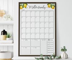 a printable calendar hangs on the wall next to a potted plant and bookshelf