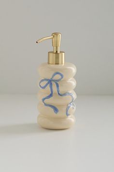 a soap dispenser with a blue ribbon on it