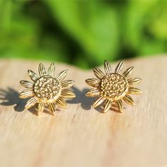 These pretty brass sunflower stud earrings are made with raw brass and feature amazing details in the design.  They make amazing gifts for anyone who loves sunflowers for brithdays, graduations, Christmas, stocking stuffers, Mother's Day, anniversaries, Valentine's Day or a just because gift.   Earring Details ❤️Made with raw brass ❤️Measure approximately 15mm ❤️Soft clear silicone earring backings for comfort ❤️Packaged on a high quality earring card and in a gift box with satin ribbon ❤️Not recommended for wear in a pool or the ocean Buy your succulent shaped stud earrings here...  https://www.etsy.com/listing/795089656/succulent-stud-earrings?ref=shop_home_active_6&crt=1 Buy your beach stud earring gift set here...  https://www.etsy.com/listing/717979389/sandy-beach-turquoise-druzy-stud Bohemian Sunflower Design Flower Earrings As Gift, Adjustable Gold Sunflower Earrings, Nickel-free Brass Flower-shaped Earrings, Gold Sunflower Adjustable Flower Earrings, Brass Flower Earrings For Gift, Bohemian Sunflower Earrings For Gift, Bohemian Sunflower Design Earrings For Gift, Bohemian Sunflower Earrings As Gift, Gold Flower Earrings For Everyday