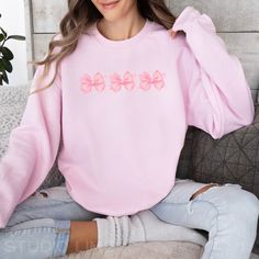 Order by December 9th, to help ensure delivery via USPS by 12/24. 📦 Elevate your style with our coquette-style crewneck sweatshirt, featuring watercolor-style pink bows that add a touch of whimsy and elegance to your wardrobe. Perfect for those who embrace playful sophistication, this sweatshirt makes a statement without saying a word. * PRODUCT DETAILS - Unisex Sweatshirt - Printed with ink - Ribbed knit collar, retains its shape even after washing. - No itchy side seams - 50% cotton, 50% poly Casual Crew Neck Top With Pink Bow, Cute Pink Crew Neck Sweatshirt, Princess Energy, Pastel Princess, Aesthetic Crewneck, Style Feminine, Coquette Style, Coquette Pink, Soft Girl Aesthetic