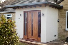 a small white building with wooden doors and windows