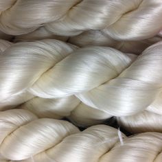 several skeins of white yarn are stacked together