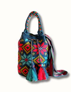 The Stargazing Wayuu Bag adds a unique and eye-catching flare to any ensemble. Crafted with a masterful touch, this one-of-a-kind design is handmade in Colombia with intricate flower detailing – an effortless way to make a bold statement. Get noticed! Dimensions: Height: 11 inches (29 cm) Width: 8.5 inches (21.5 cm) Multicolor Handwoven Bucket Bag As A Gift, Artisan Multicolor Bucket Bag With Adjustable Strap, Traditional Multicolor Bucket Bag With Adjustable Strap, Artisan Multicolor Bag With Adjustable Strap, Bohemian Weaving Bucket Bag, Multicolor Woven Bucket Bag For Travel, Multicolor Woven Bucket Bag As Gift, Multicolor Weaving Bucket Bag For Travel, Multicolor Woven Bucket Bag Gift