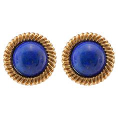 Center Stone: 2 Lapis Lazuli Cut: Cabochon Cut Weight: Approximately 20 Carats Color: Blue Metal: 18K Yellow Gold Era: Vintage Circa: 1970s Size: 7/8 inches diameter Gram weight: 15.3 These striking vintage earrings feature two cabochon cut lapis lazuli stones, totaling approximately 20 carats. The deep blue hue of the lapis lazuli is beautifully complemented by the 18K yellow gold setting. Crafted in the 1970s, these earrings capture the bold and elegant style of the era. Measuring 7/8 inches i Colored Stone Engagement Rings, Vintage Drop Earrings, Lapis Lazuli Jewelry, Lapis Lazuli Earrings, Gold Cocktail Ring, Lapis Lazuli Stone, Gold Clips, Yellow Gold Setting, Yellow Gold Earring