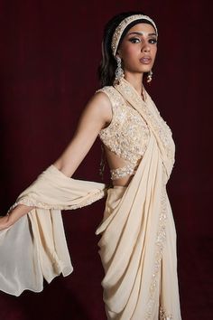 Beige pre-draped saree with sequins and cutdana embroidery in floral pattern. Paired with an embroidered padded blouse and belt. - Aza Fashions Elegant Pre-draped Saree With Cape Sleeves For Wedding, Elegant Draped Wedding Saree, Embellished Pre-draped Saree For Wedding, Wedding Pre-draped Saree With Cape Sleeves, Elegant Fitted Pre-draped Saree With Cape Sleeves, Elegant Pre-draped Saree With Cape Sleeves, Elegant Fitted Pre-draped Saree With Traditional Drape, Elegant Floor-length Pre-draped Saree, Cutdana Embroidery