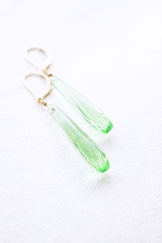 Long Gold, Peridot Quartz Teardrop Earrings, No. EGL031 :*About This Piece*: ♦︎ Elegant and classy, these bright green Peridot Quartz Drops have a vintage appeal with a timeless elegance hung from gold filled lever back earrings. ♦︎ Length - 2.2 in (55 mm) ♦︎ Width - .3 in (7 mm) ♦︎ All items from my shop are packaged in padded cardboard jewelry boxes. Custom gifting options available upon request. ♦︎ Visit my shop for more here: https://www.etsy.com/shop/storygirlcreations ♦︎ Are you looking fo Green Drop Teardrop Earrings For Formal, Green Faceted Teardrop Earrings, Green Teardrop Earrings For Formal Occasions, Green Teardrop Earrings For May Birthstone, Formal Green Teardrop Drop Earrings, Green Teardrop May Birthstone Earrings, Green Long Drop Earrings For Formal Occasions, Green Faceted Earrings For Wedding, Green Long Drop Earrings