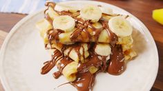 bananas and chocolate sauce on top of pancakes