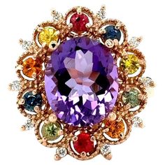 4.98 Carat Oval Cut Amethyst Diamond Sapphire Rose Gold Cocktail Ring This beautiful vintage inspired setting with a modern colorful theme has an Oval Cut Amethyst weighing 3.93 carats and is surrounded by 10 Round Cut Multi-Colored Sapphires that weigh 0.94 carats and 10 Round Cut Diamonds weighing 0.11 carats. The total carat weight of the ring is 4.98 Carats. The Amethyst measures at approximately 9 mm x 11 mm and the face of the ring measures approximately at 18 mm x 23 mm. The ring is made Multicolor Oval Amethyst Ring With Gemstone Accents, Multicolor Oval Amethyst Ring With Accent Stones, Multicolor Oval Gemstone With Center Stone, Multicolor Oval Amethyst Gemstone Ring, Multicolor Oval Amethyst Ring, Oval Multicolor Rings For Collectors, Oval Multicolor Rings For Collectible, Rose Gold Cocktail, Colored Sapphires