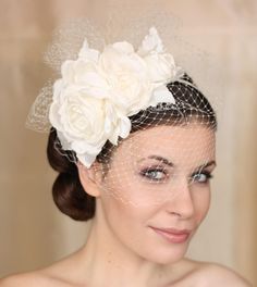 a woman wearing a veil and flowers in her hair