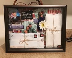 an air force photo frame with photos and a flower tied up to it's side