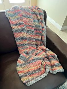 a blanket that is sitting on top of a couch